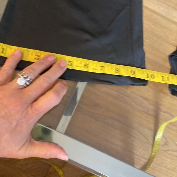 Put on black flare pants with cut out waste accent and silver accessory. Stretch - Picture 5 of 11